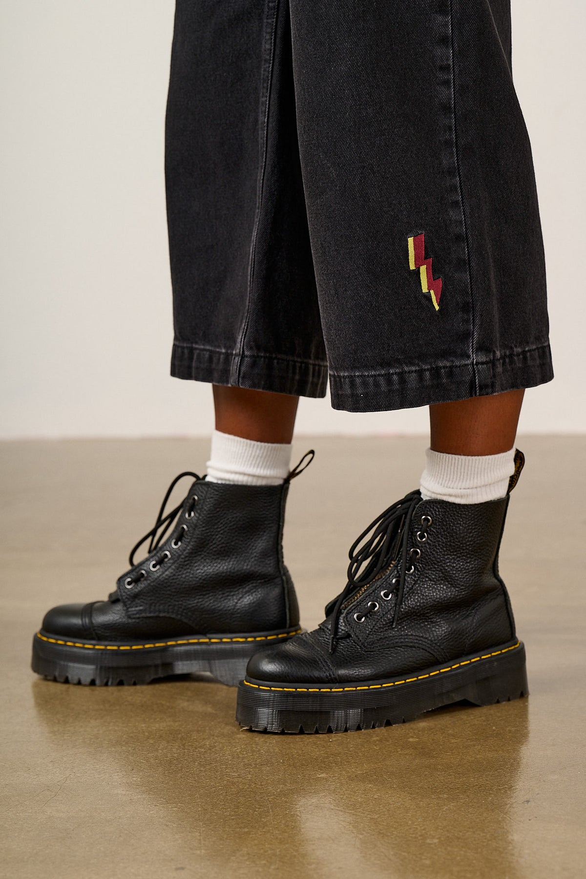Ragan - Cropped Leg Jumpsuit Organic Cotton Denim in Washed Black with Punk Energy Patches